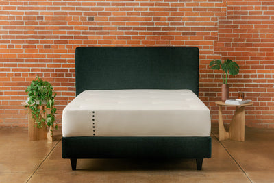 Devon hybrid mattress with organic cotton herringbone fabric cover on top of padded base platform bed with headboard