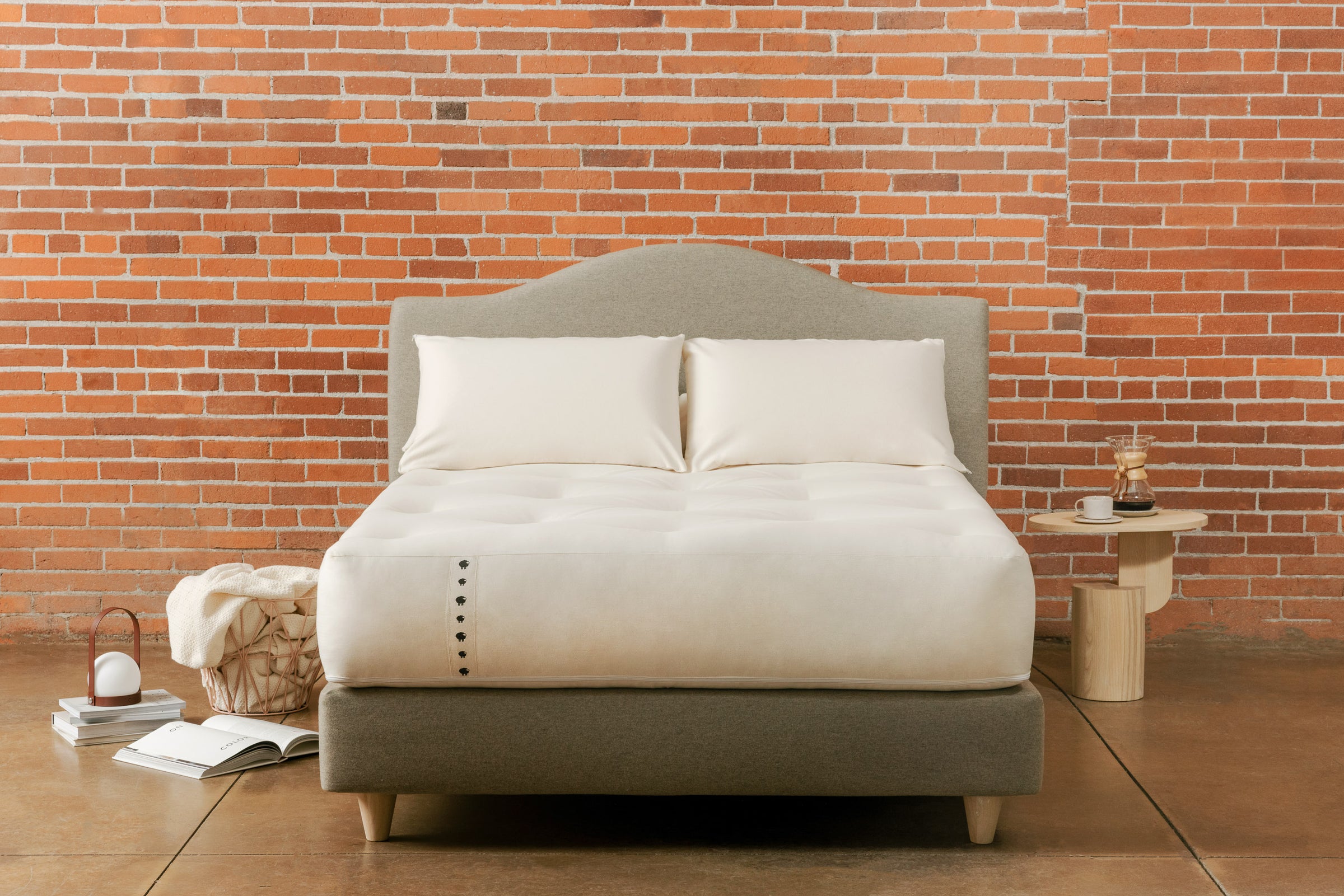 Natural latex pillows on top of suffolk spring mattress and padded base platform bed with matching headboard