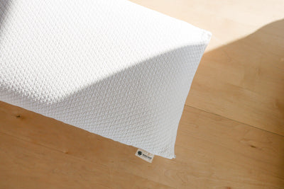 Natural latex pillow with organic cotton cover on wood top desk
