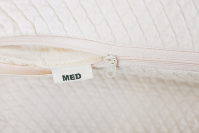 Tag on natural latex pillow describing the firmness as medium
