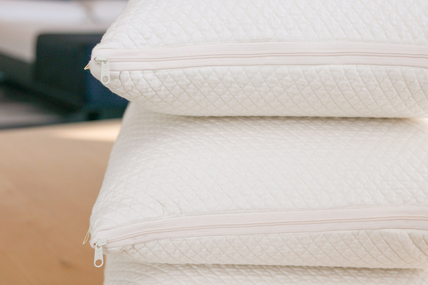 Stack of three 100% natural talalay latex pillows showing the zipper on the organic cotton case