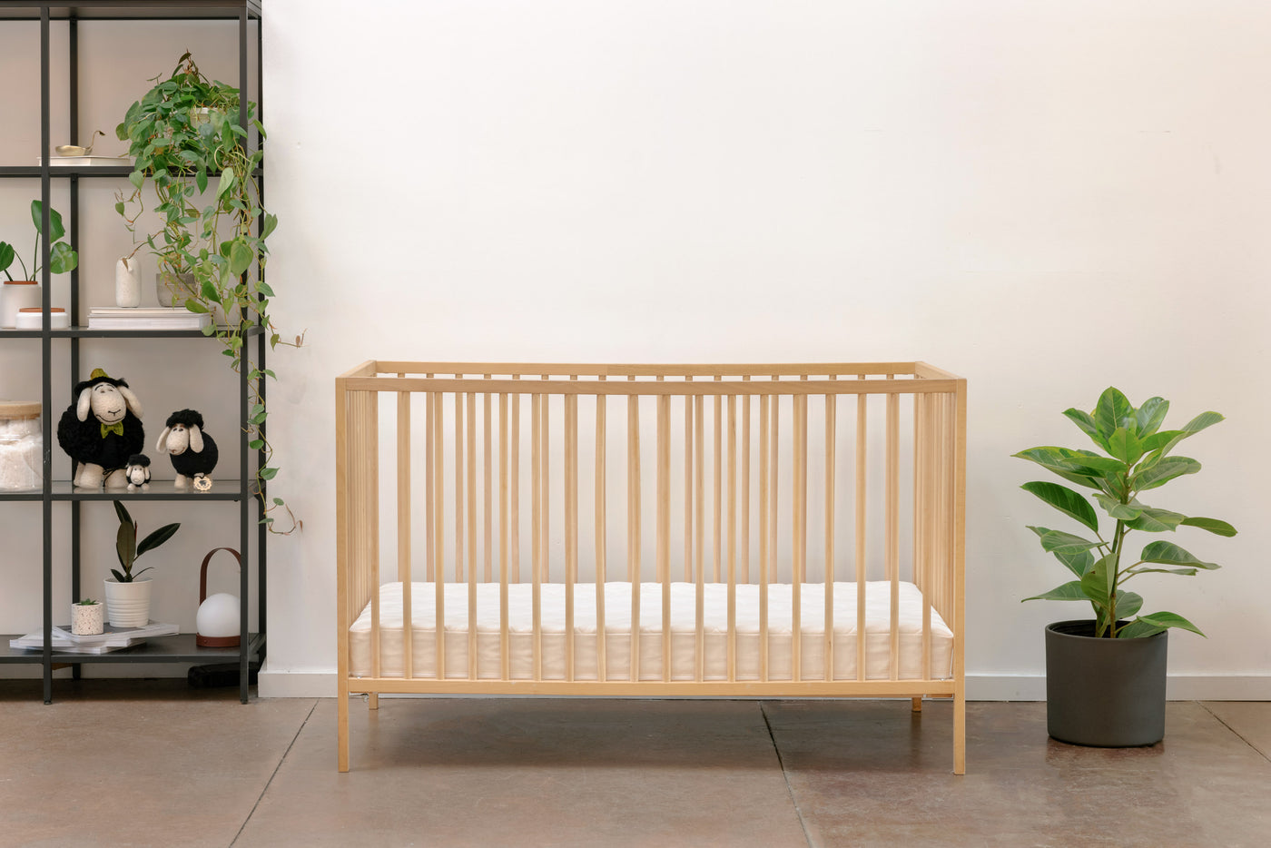 Lil' Oxford Crib Mattress shown in a wooden crib