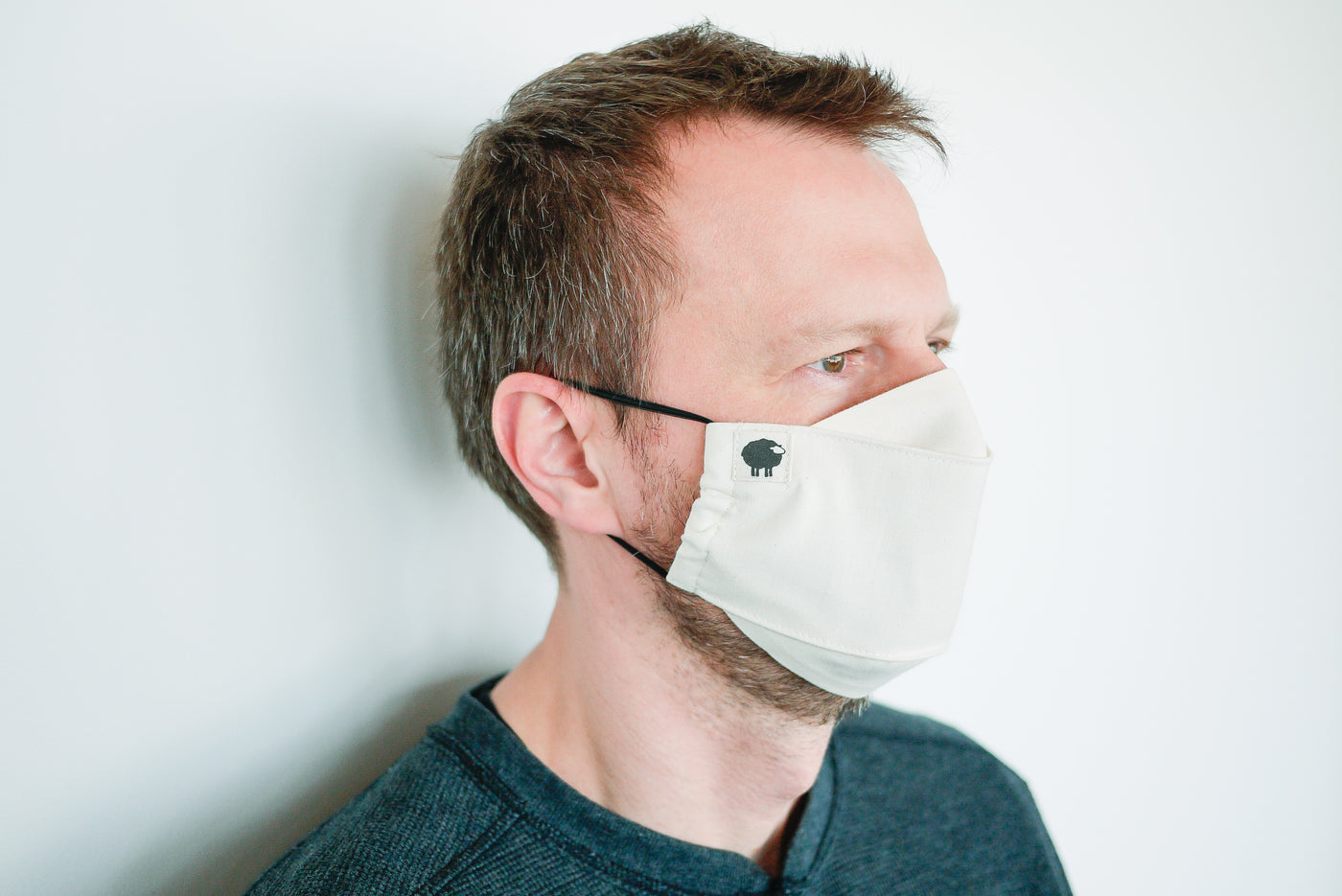 Man wearing contoured organic cotton face mask with adjustable elastics