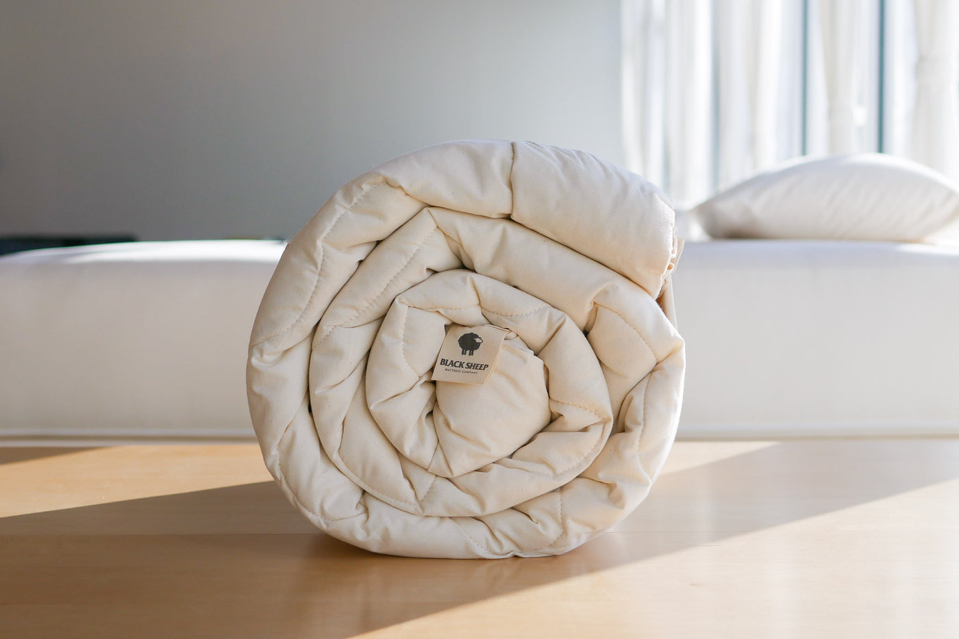Rolled up natural wool duvet made in Calgary, AB by Black Sheep Mattress Company
