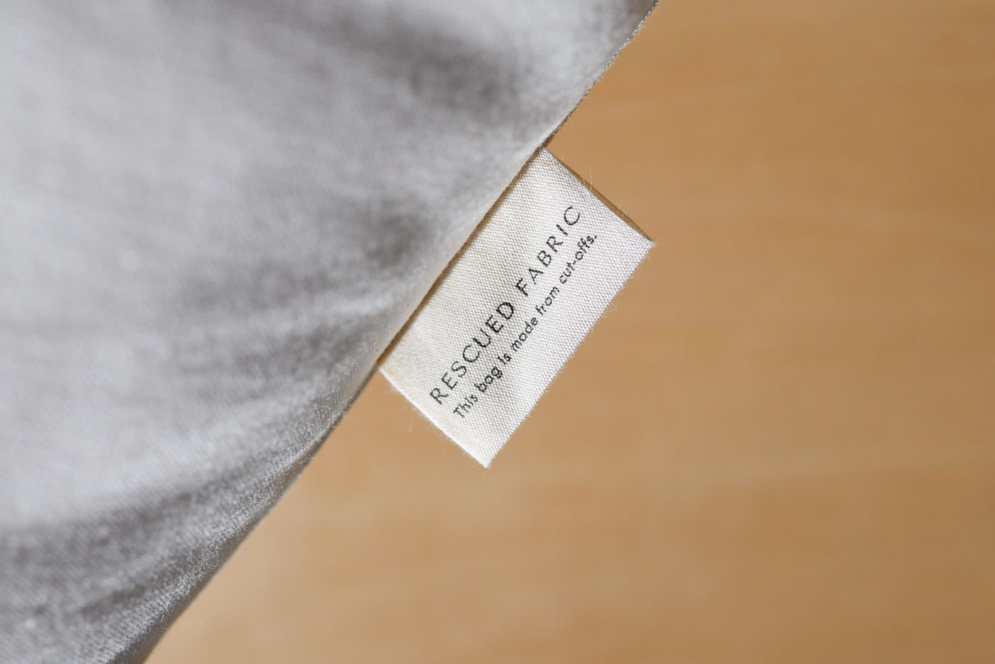 Tag on cotton canvas bag that says Rescued Fabric: this bag is made from cut-offs