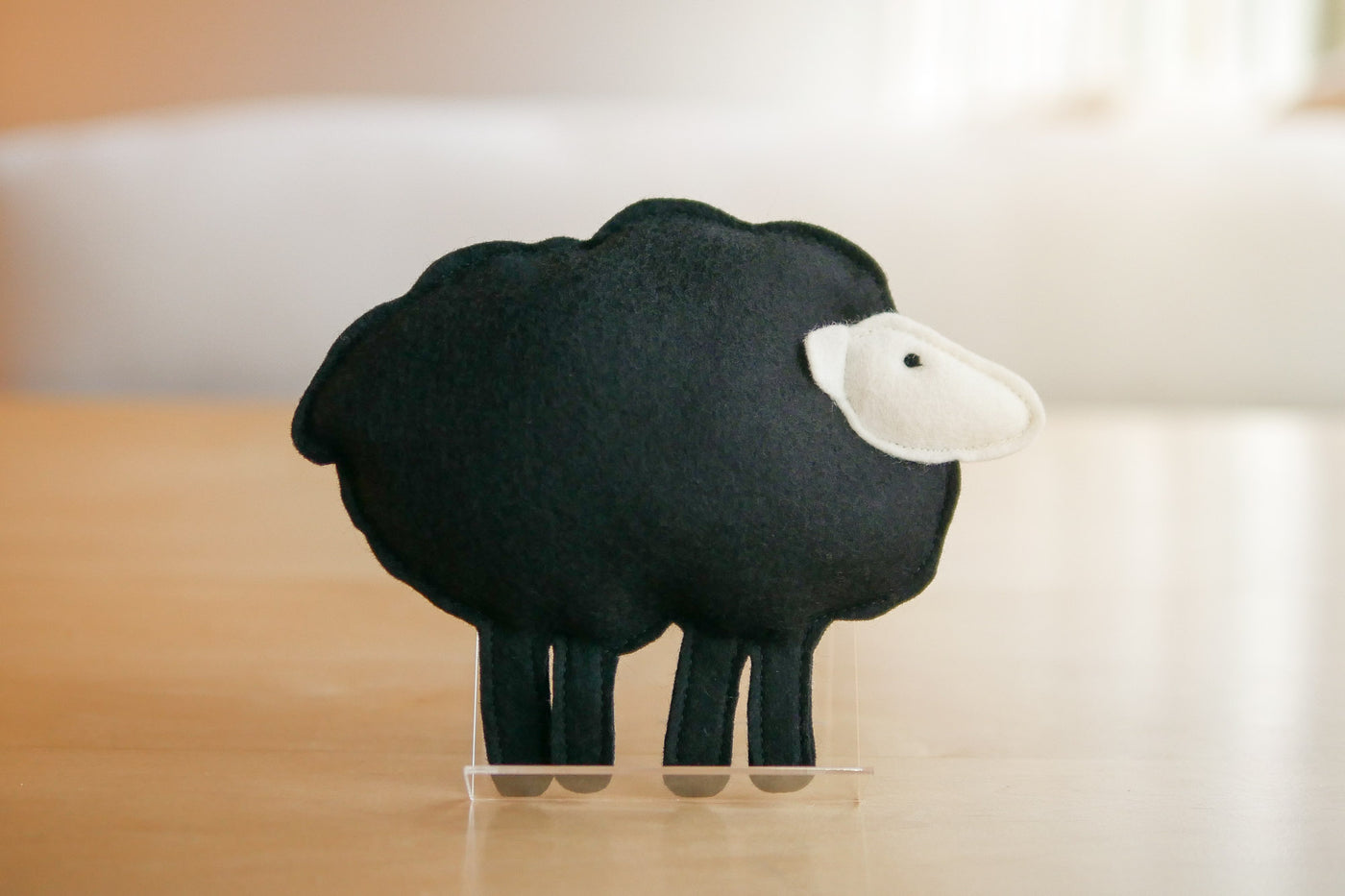 Wool sheep toy standing on holder
